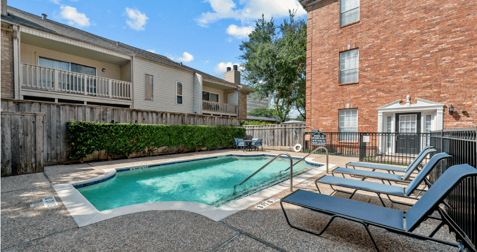 Luxury townhomes with swimming pool and poolside lounge seating at Tuscany Row in Houston.