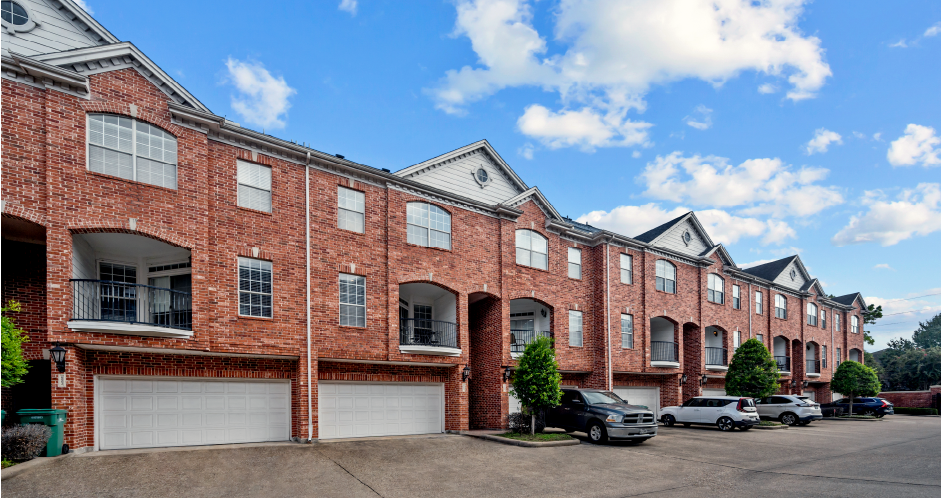 Luxury townhomes in a gated community with red brick exteriors and attached 2-car garages at Tuscany Row Townhomes in Houston.
