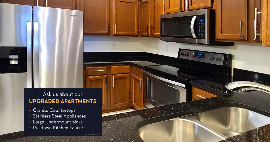 Luxury apartments with spacious kitchens, granite countertops, kitchen stainless steel appliances, and designer tile backsplash at Tuscany Walk Apartments in Houston Texas.