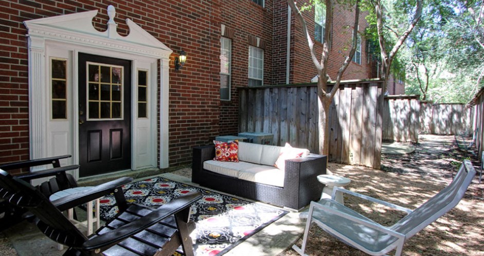 Private backyard patios and red brick exteriors at Tuscany Villas in Houston.