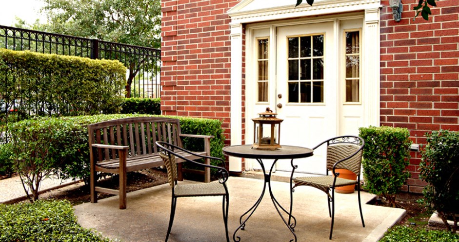 Private backyard patios and red brick exteriors at Tuscany Villas in Houston.