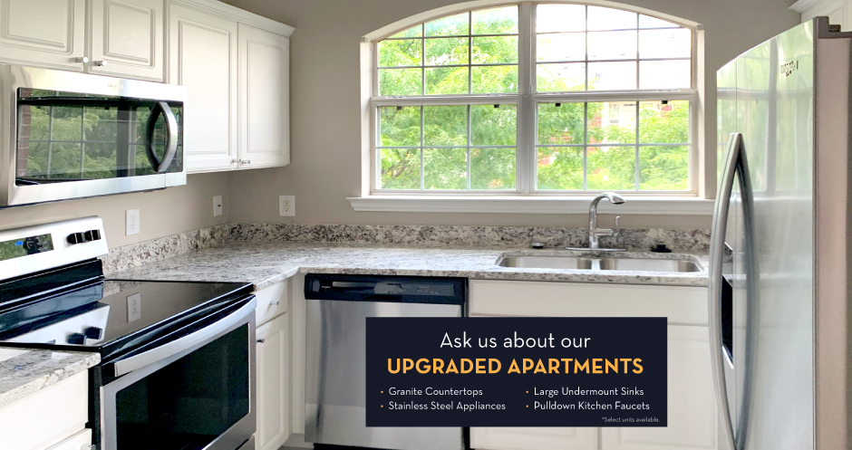 Luxury apartments with granite countertops, white cabinets, stainless steel appliances, and side-by-side refrigerator at Saddlebrook apartments in Urbandale Iowa
