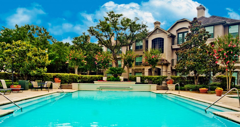 Luxury swimming pool with poolside lounges, 2 resort-style swimming pools with spa, beautiful landscaping, lush landscaping at Village on the Parkway Apartments.