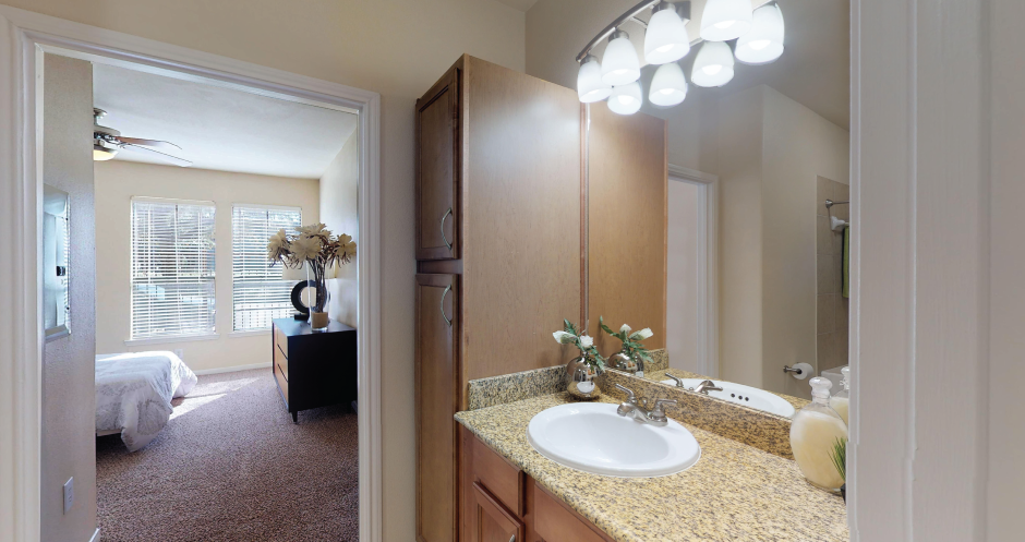 Luxury apartments with spacious bathroom with oval soaking tub, and spacious linen closet at The Voss Apartments in Houston.