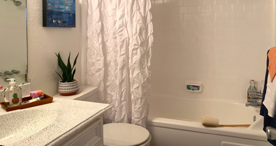 a bathroom with a shower and a toilet and a sink