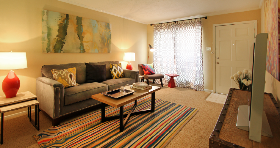 Spacious one and two bedroom floor plans with white brick accent walls at Waters of Winrock Apartments in Houston.