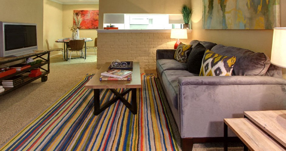 Spacious one and two bedroom floor plans with white brick accent walls at Waters of Winrock Apartments in Houston.