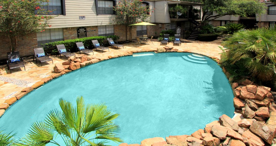 Gated apartment community close to the Galleria with pool, spa, poolside lounge chairs, lush landscaping, beautiful landscaping, and neighborhood setting.