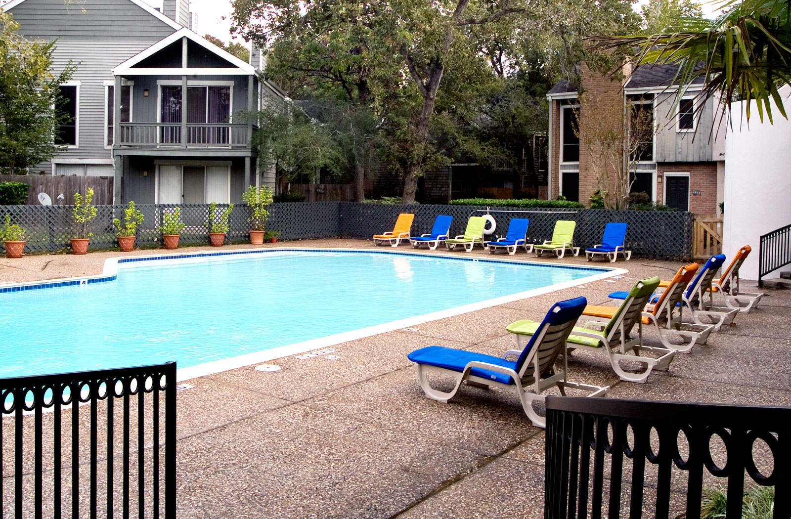 Gated apartments with 4 swimming pools, convenient bayou location, lush landscaping and scenic views at Woodlake on the Bayou Apartments in Houston.