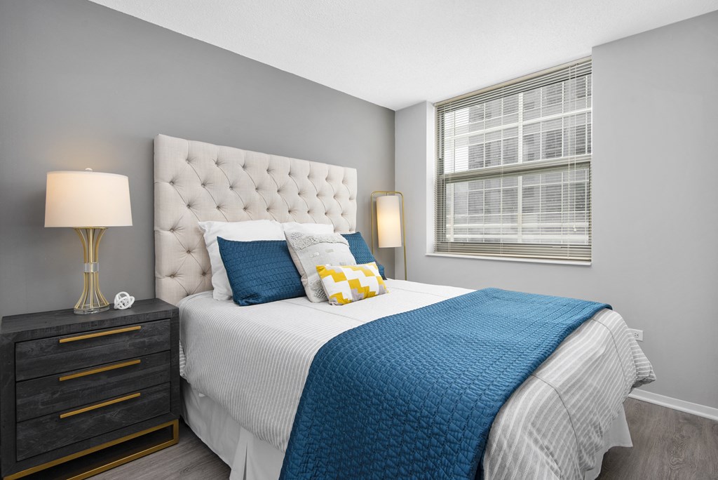 a bedroom with a large bed and a window