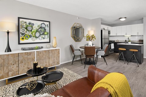 a living room with a couch and a table and a kitchen