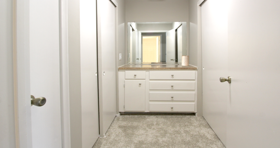Recently updated apartments with gray wall color, white cabinets, and extra storage space at Kensington Woods Apartments in Omaha, Nebraska