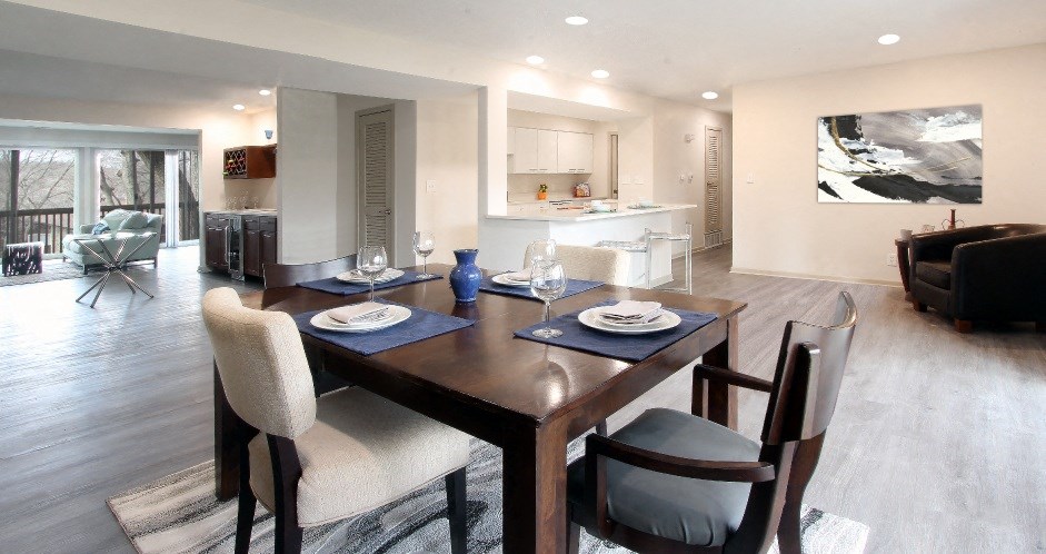 a dining room and living room with a table and chairs