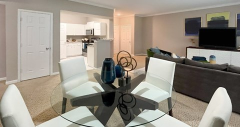 Apartments in southwest Omaha with spacious layout, spacious living room, spacious dining room, granite countertops, white kitchen cabinets, and stainless-steel appliances at Breckenridge Apartments in southwest Omaha, Nebraska
