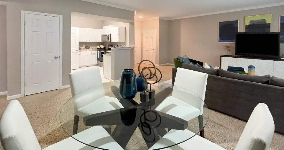 Apartments in southwest Omaha with spacious layout, spacious living room, spacious dining room, granite countertops, white kitchen cabinets, and stainless-steel appliances at Breckenridge Apartments in southwest Omaha, Nebraska