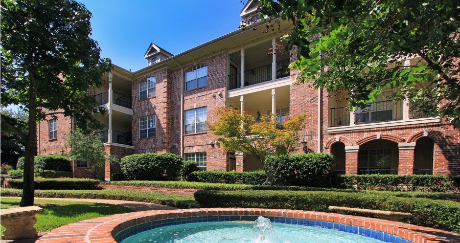 Gated apartment community with landscaped courtyards, beautiful landscaping, and beautiful courtyards with fountains at The Saxony Apartments in north Dallas