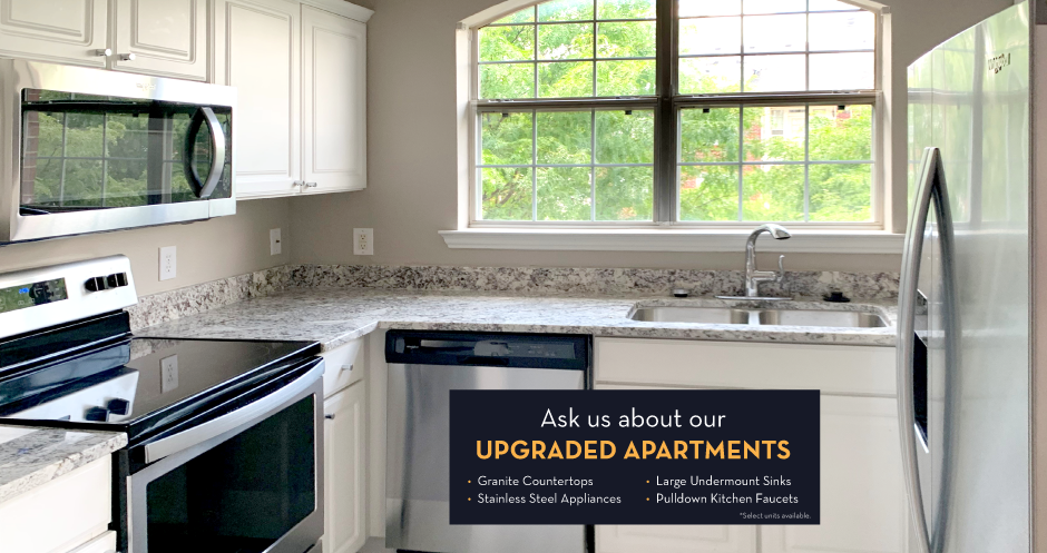 Luxury apartments with granite countertops, white cabinets, stainless steel appliances, and side-by-side refrigerator at TurtleCreek apartments in West Des Moines, Iowa