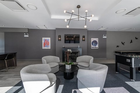 A room with grey walls and a pool table.