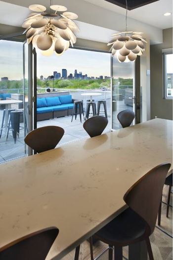 A modern dining area with a view of the city skyline.