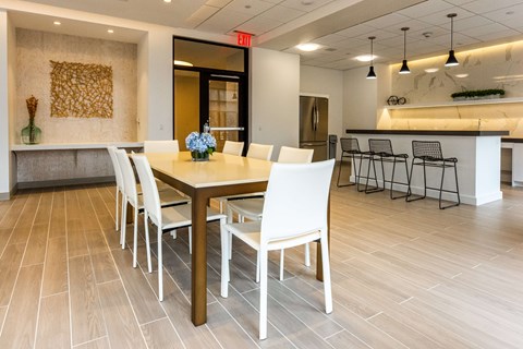 A dining room with a table set for four.