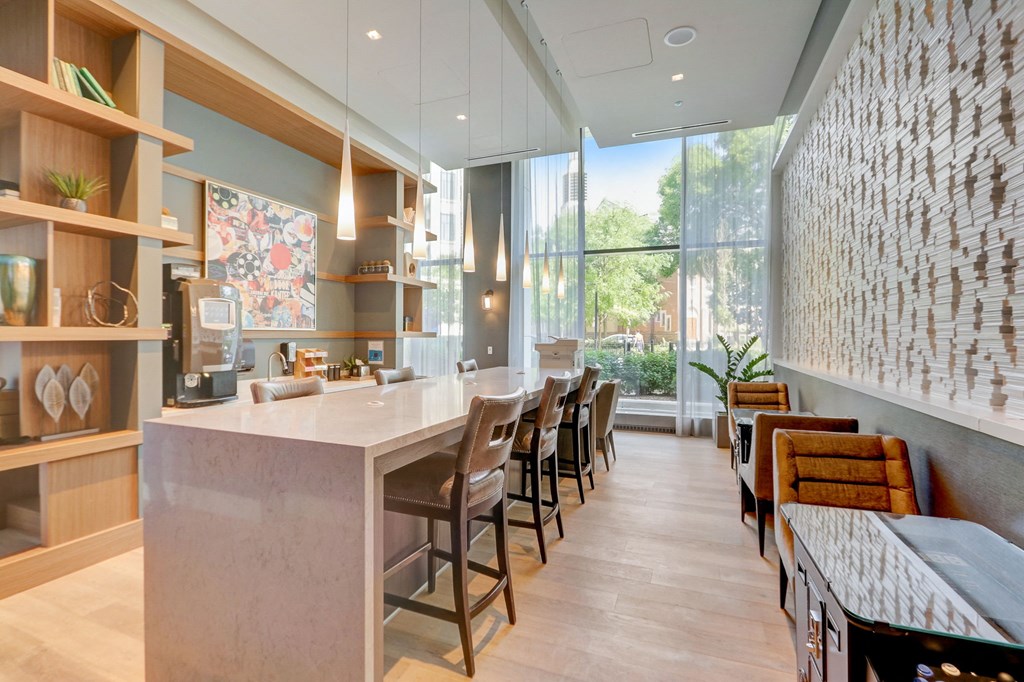 Kitchen with a long counter top next to a window at The Apartments at Lincoln Common, Chicago, IL, 60614
