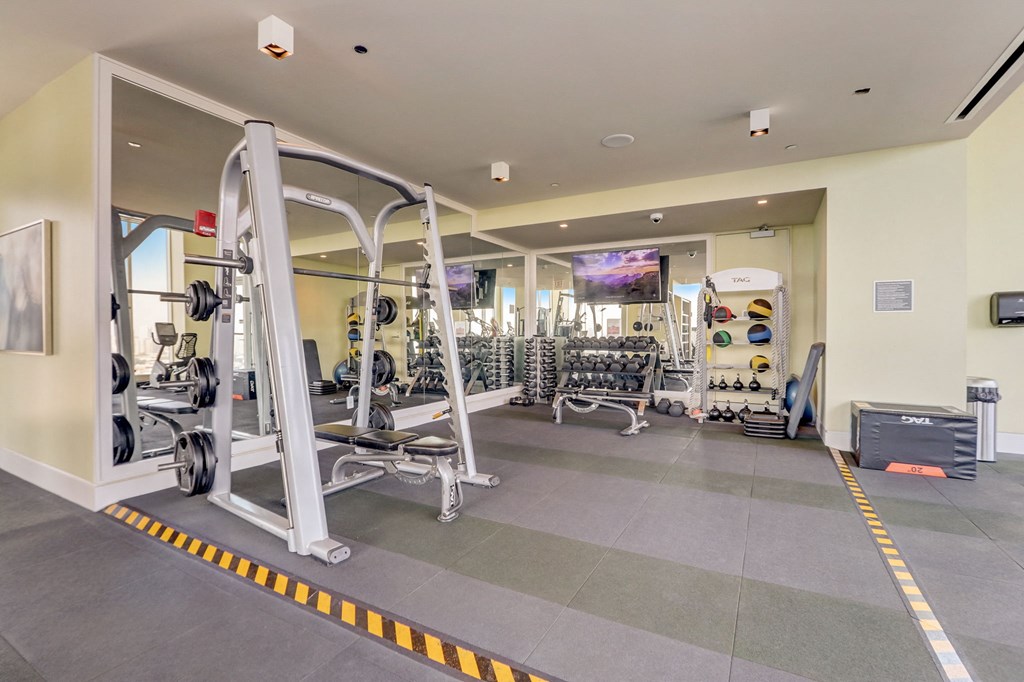 Gym with weights and other equipment at The Apartments at Lincoln Common, Chicago