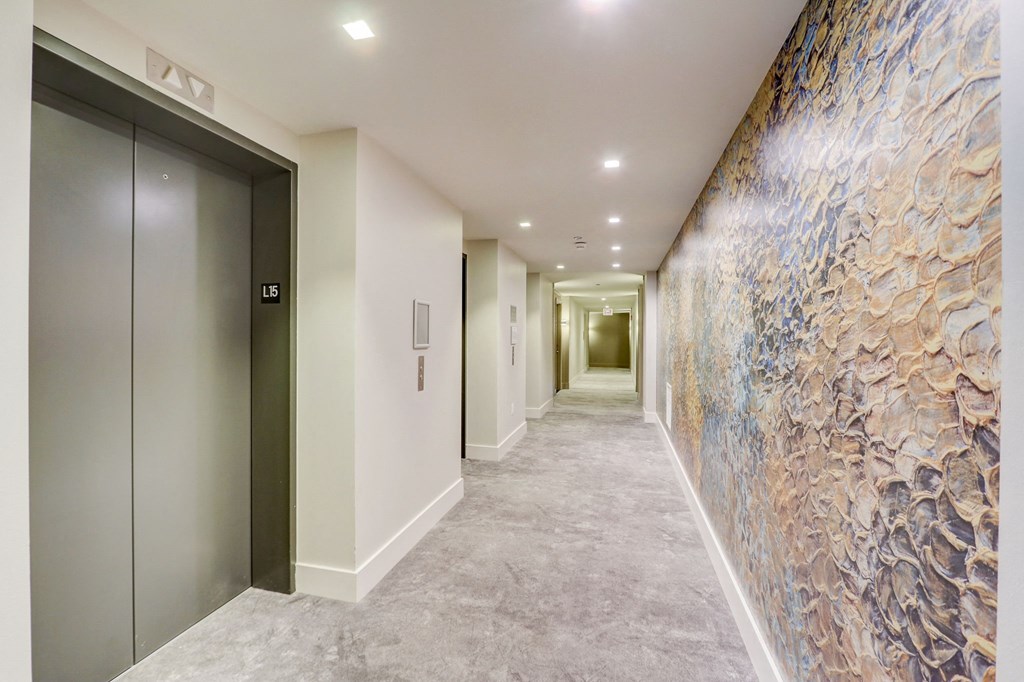 Long corridor with a large mural on the wall at The Apartments at Lincoln Common, Chicago, 60614