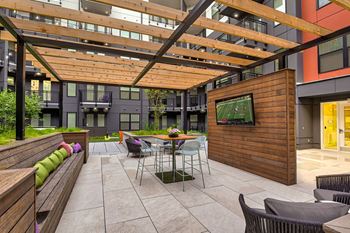 a living room with a table and chairs and a bar