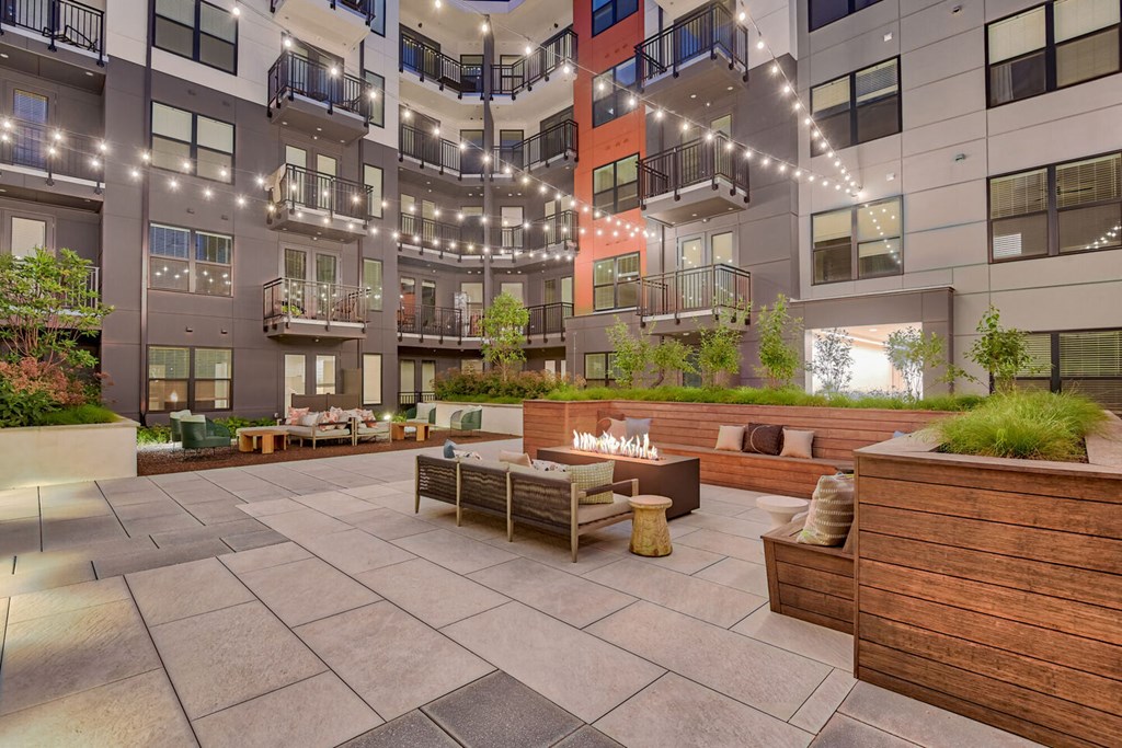 an open courtyard with furniture and a fire pit