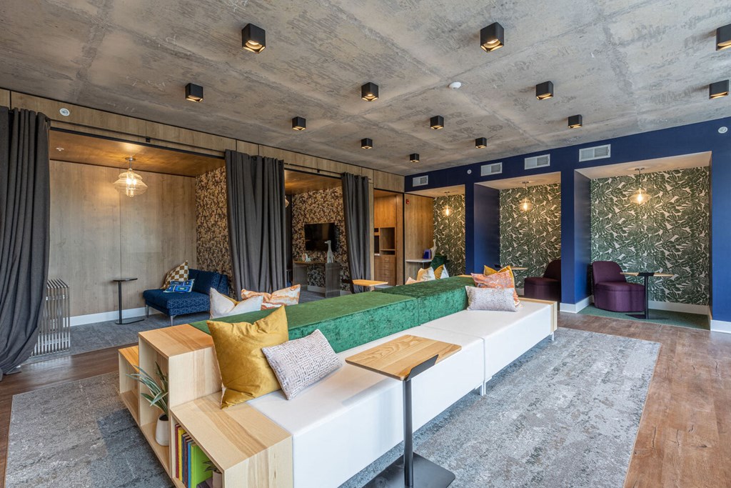 a living room with blue walls and a green couch