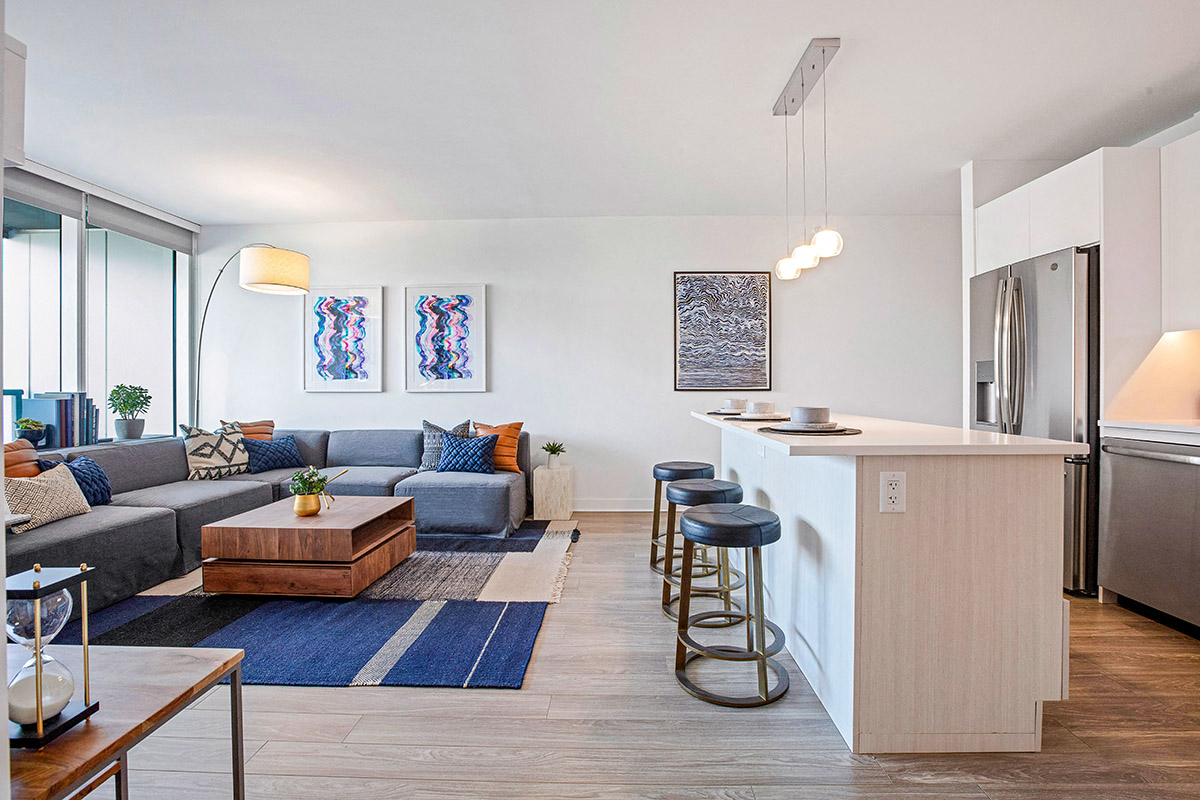 a living room with a couch and a kitchen