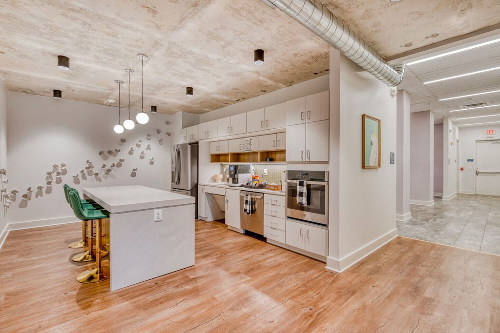 a kitchen with white cabinets and a counter top in a living room