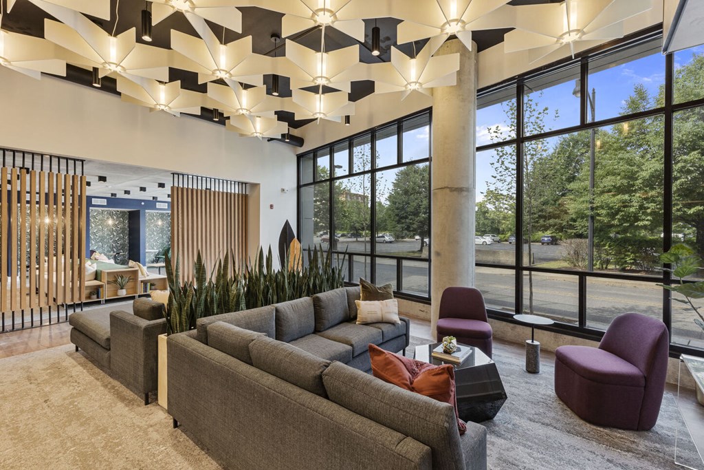 the lobby of a hotel with a large couch and chairs