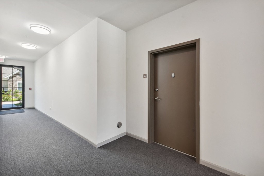 a room with white walls and a door in the corner
