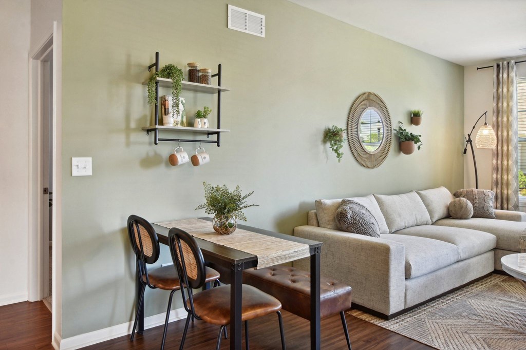 a living room with a couch and a table with chairs