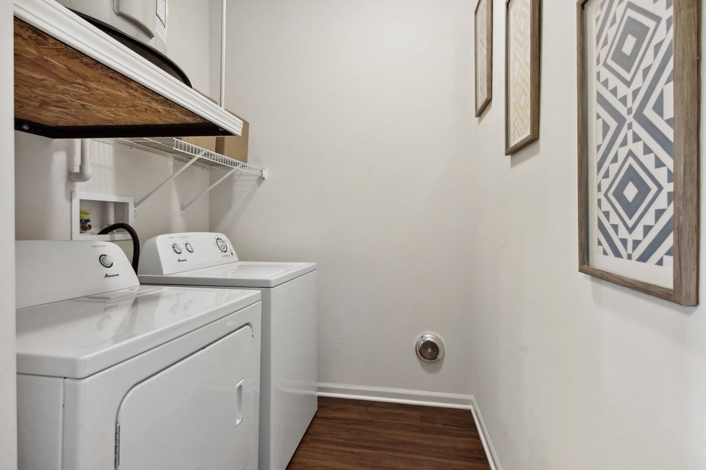 a small laundry room with a washer and dryer in it and a sink