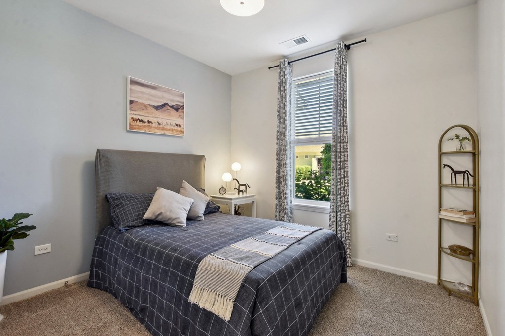 a bedroom with a bed and a window