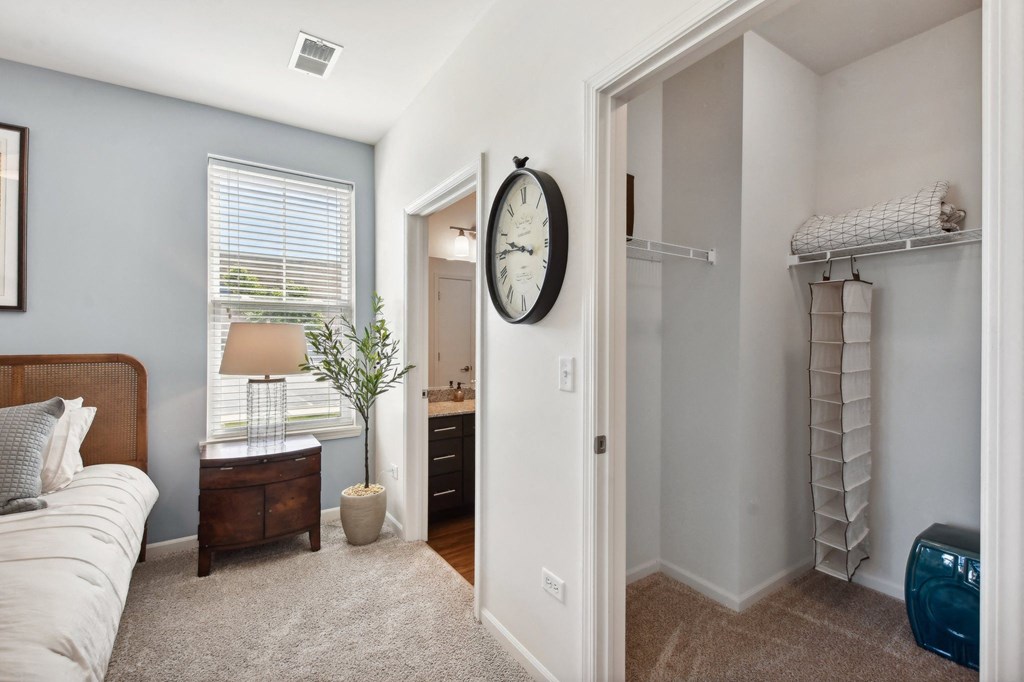 a bedroom with a large clock on the wall and a closet