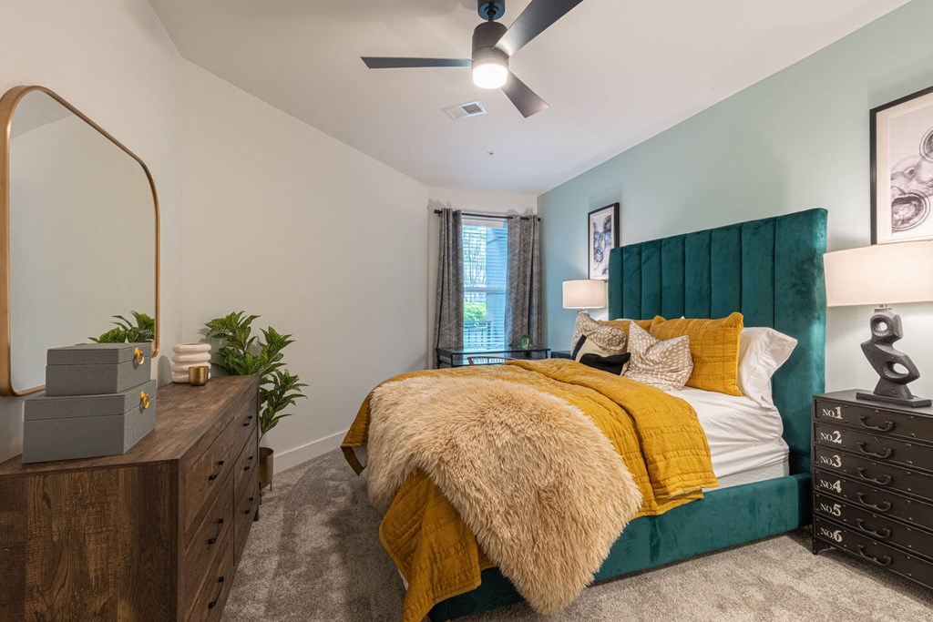 a bedroom with a bed and a ceiling fan