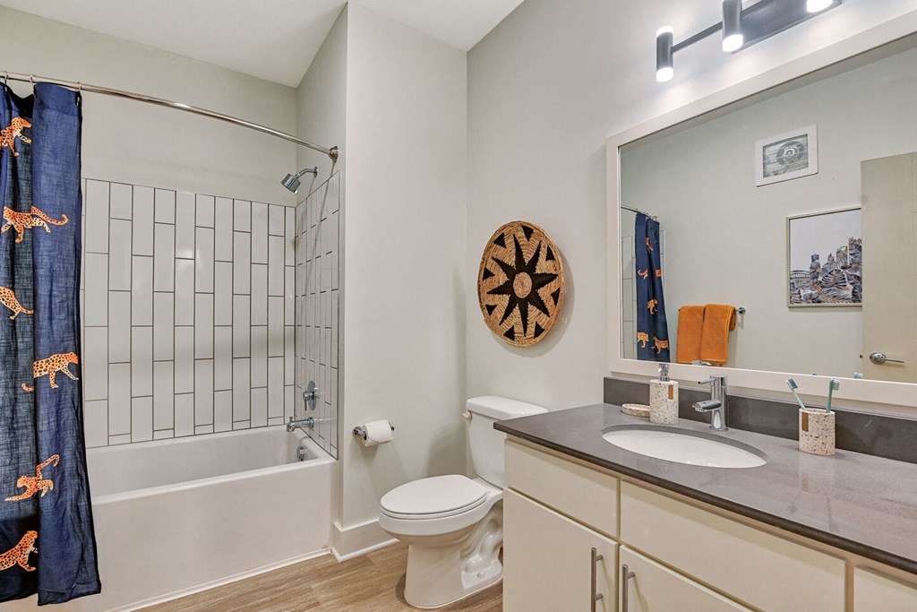 a bathroom with a sink toilet and shower