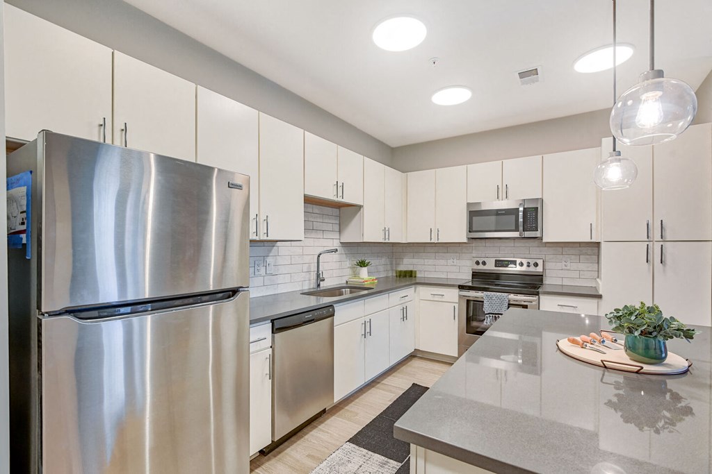 a kitchen with stainless steel appliances and white cabinets