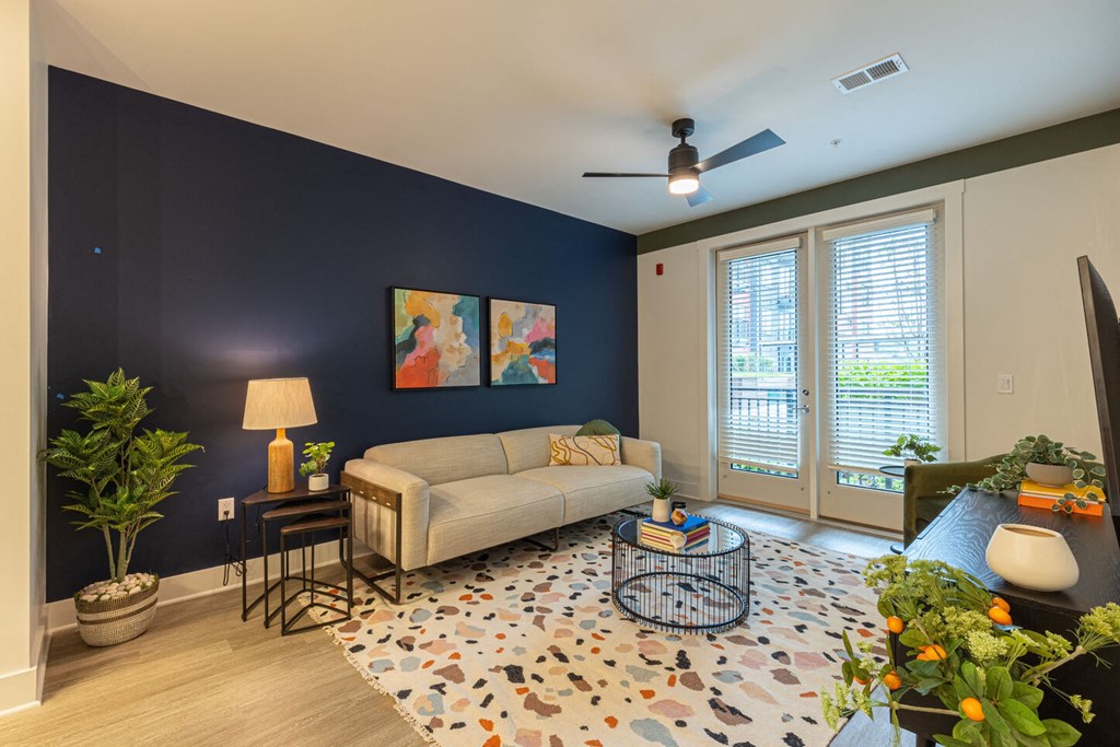 a living room with a blue accent wall and a couch