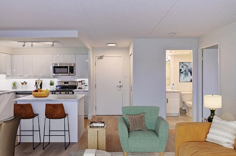 a living room with a kitchen and an open floor plan