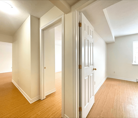 A room with a white door and a window.