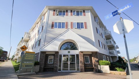 A white building with a sign that says "Appt. Residence" in front of it.