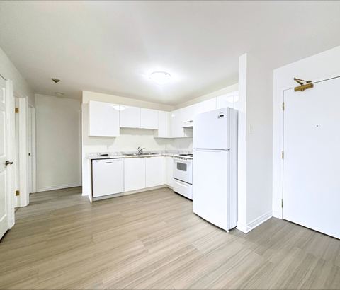 A kitchen with white appliances and cabinets.