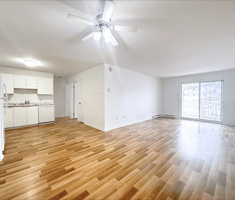 A room with wooden flooring and a ceiling fan.