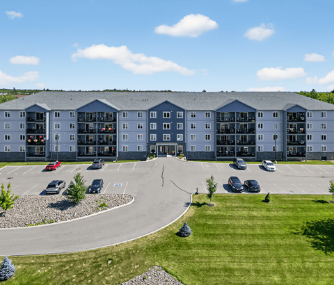 A large building with a parking lot in front of it.