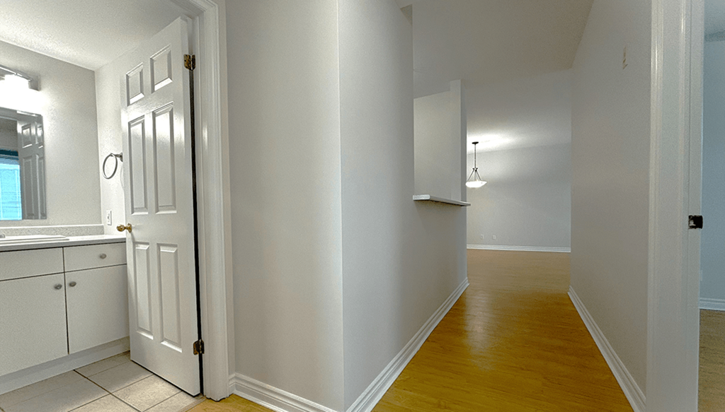 A white door is open to a hallway.