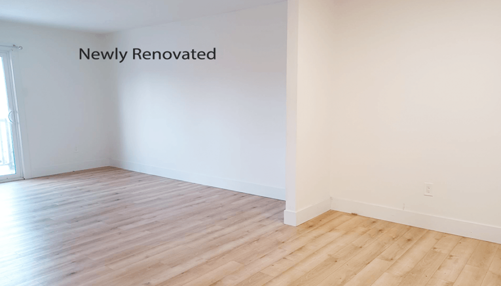 A newly renovated room with wooden flooring.